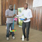 A teacher from BHS Buea receives prizes on behalf of his students