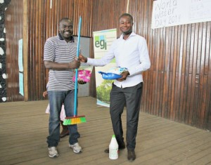 A teacher from BHS Buea receives prizes on behalf of his students